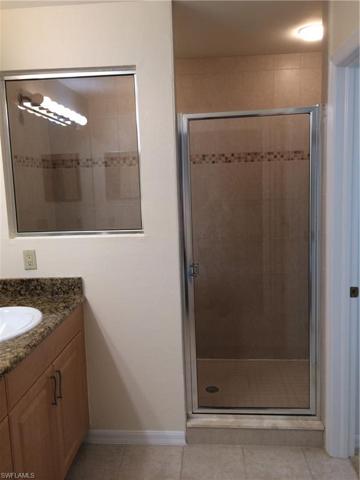 Walk in shower with large glass window and shower door.