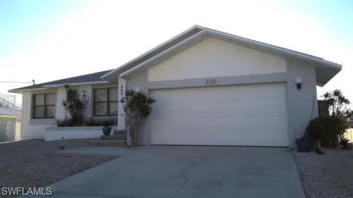 View of front of home featuring an attached garage and concrete driveway