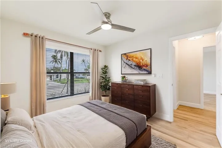 Bedroom with light wood finished floors and a ceiling fan