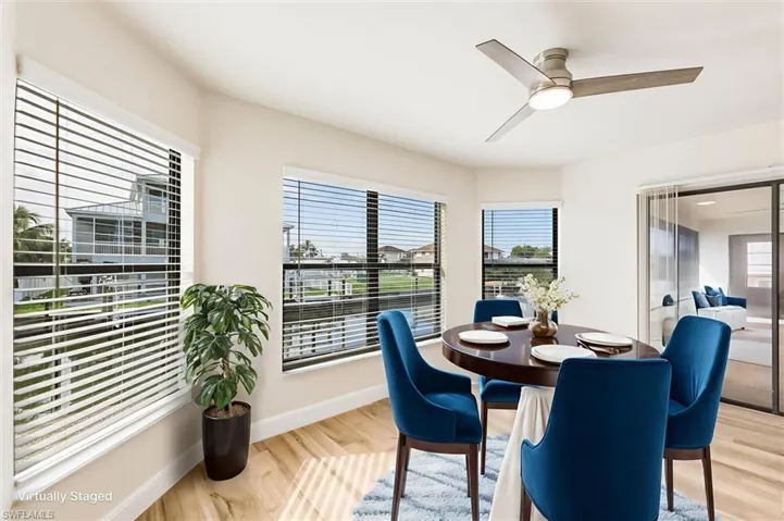 Dining room with light wood-style floors and a ceiling fan