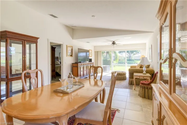 Dining area with tile flooring and a vaulted ceiling
