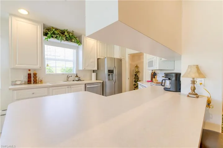 Kitchen featuring a light-toned countertop island