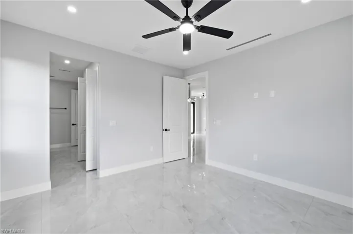 Unfurnished bedroom featuring recessed lighting, ceiling fan, and light marble finish floors
