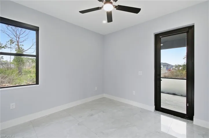 Empty room with baseboards and a ceiling fan