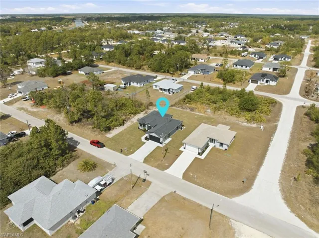 Aerial view of property's location featuring nearby suburban area