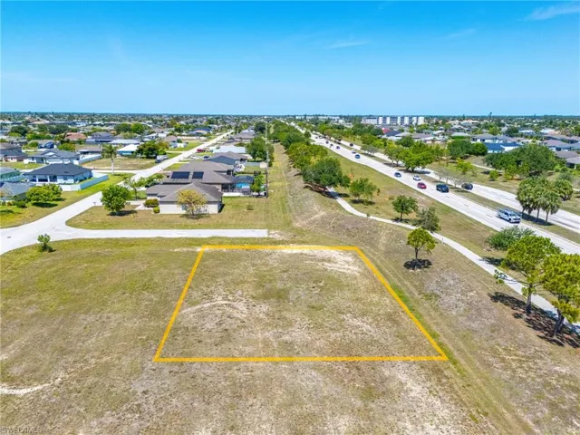 Aerial view of property and surrounding area with property parcel outlined