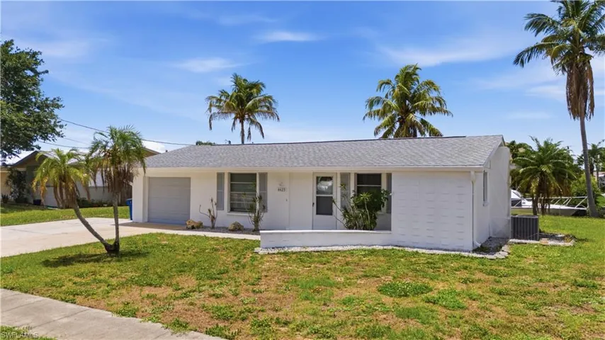 White facade with a single-car garage and a light gray shingle roof
