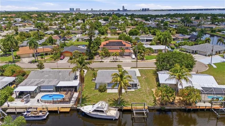 Waterfront property featuring a private boat dock, boat lift, and canal access