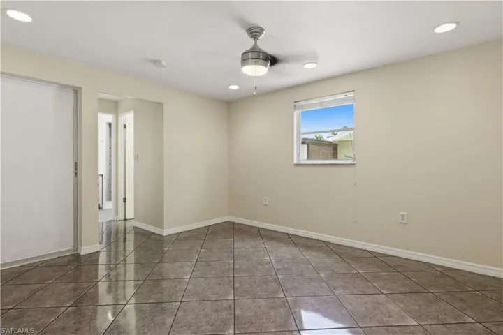 Neutral tone walls complemented by a multi-directional ceiling fan with integrated lighting