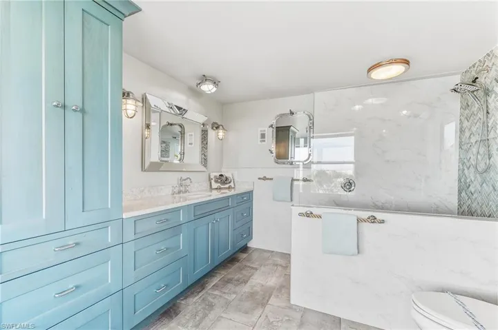 Full bathroom with vanity and a marble finish shower