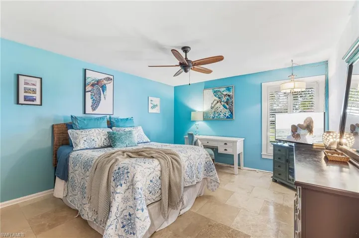 Bedroom with a ceiling fan and baseboards