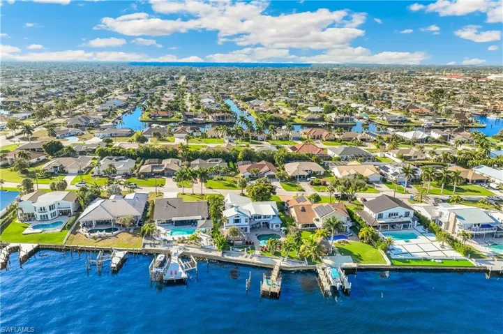 Aerial view of residential area featuring a large body of water