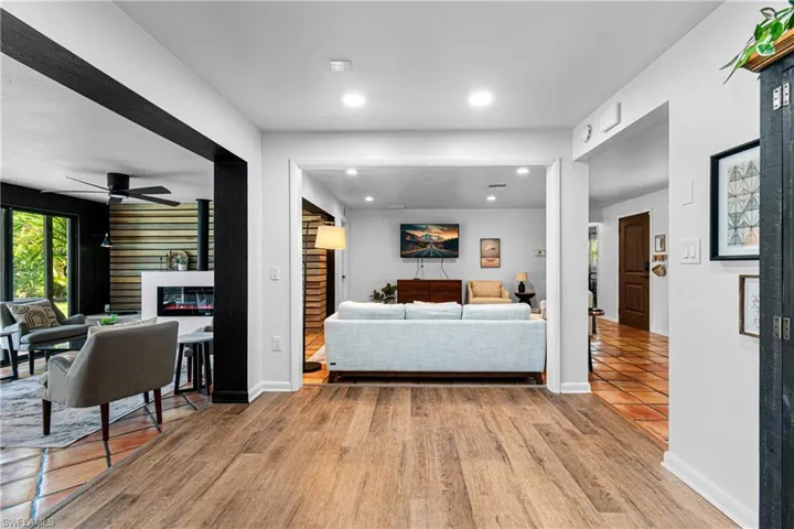 Living room with light hardwood / wood-style flooring and ceiling fan