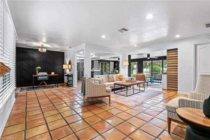 Tiled living room featuring ceiling fan