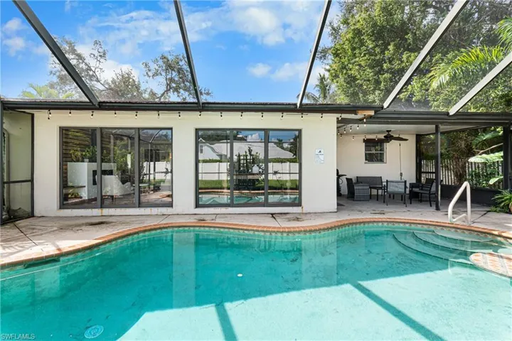 View of pool featuring a patio, a lanai, and ceiling fan