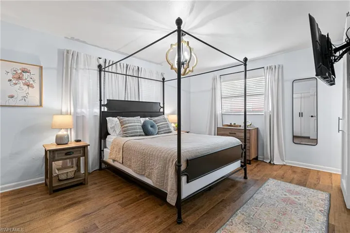 Bedroom featuring a notable chandelier and hardwood / wood-style flooring