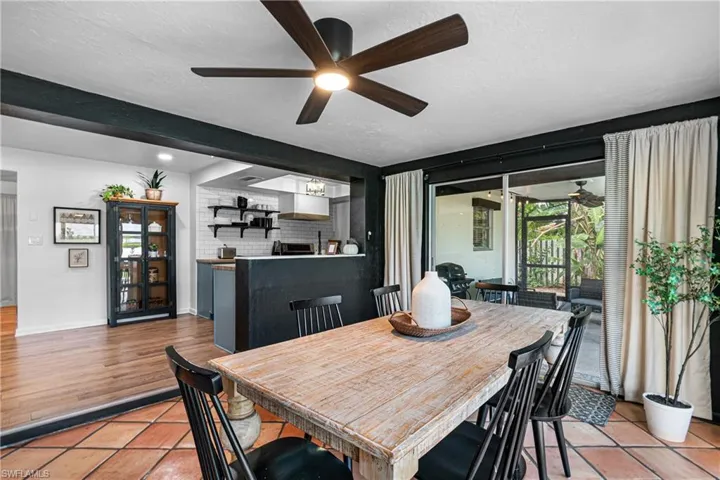 Dining space with a textured ceiling, light hardwood / wood-style floors, and ceiling fan