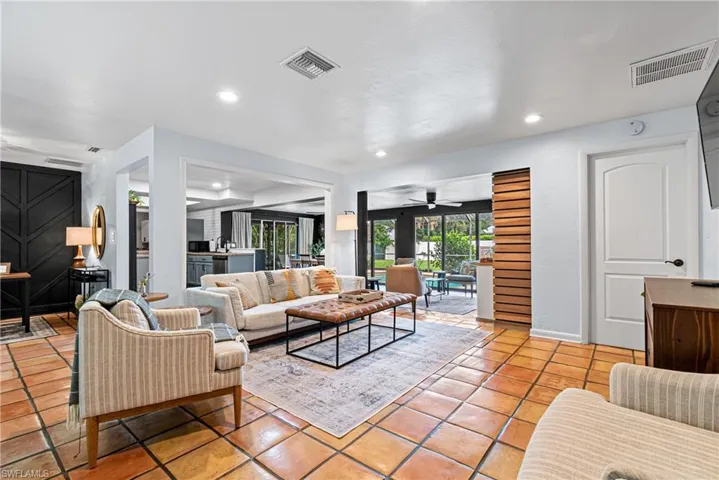 Tiled living room featuring ceiling fan
