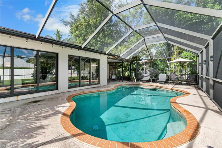 View of pool featuring a lanai and a patio area