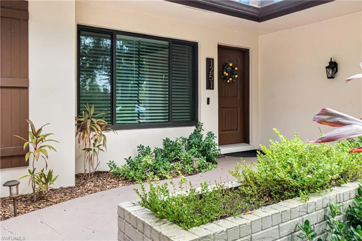 View of front of house featuring a garage and a front yard