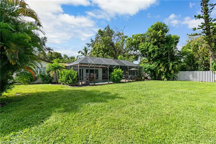 View of yard with a pool and a lanai