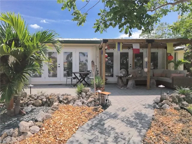 Back of house with french doors, a patio area, and an outdoor hangout area
