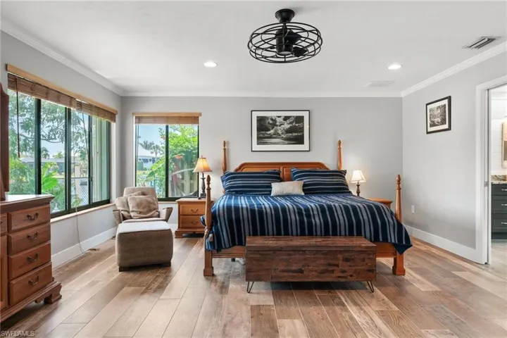 Bedroom with crown molding, light wood-type flooring, and recessed lighting
