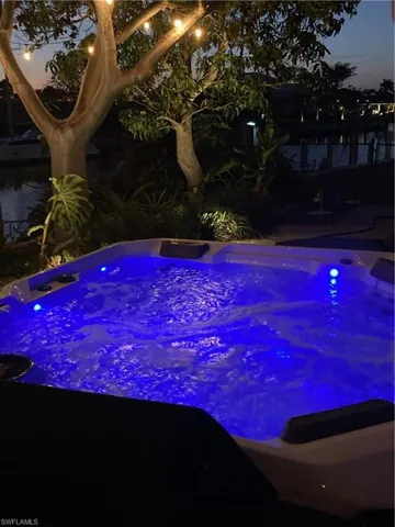 View of pool with a hot tub