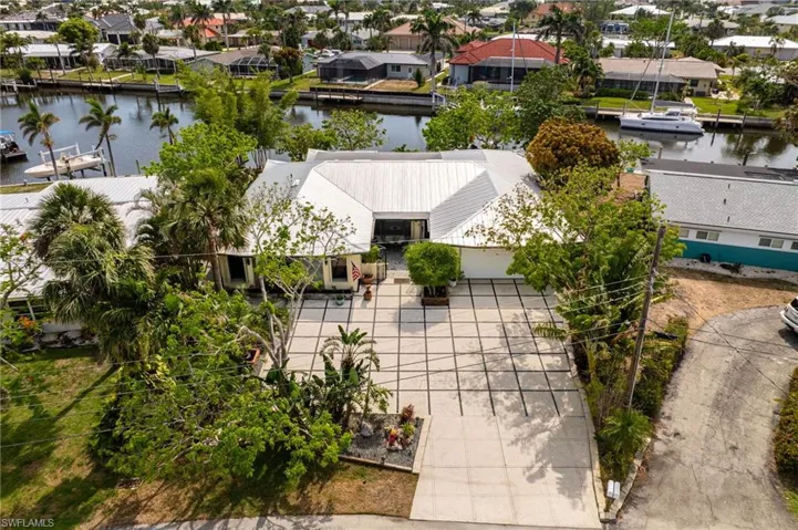 Aerial perspective of suburban area featuring a large body of water