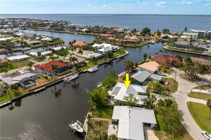 Aerial perspective of suburban area featuring a large body of water