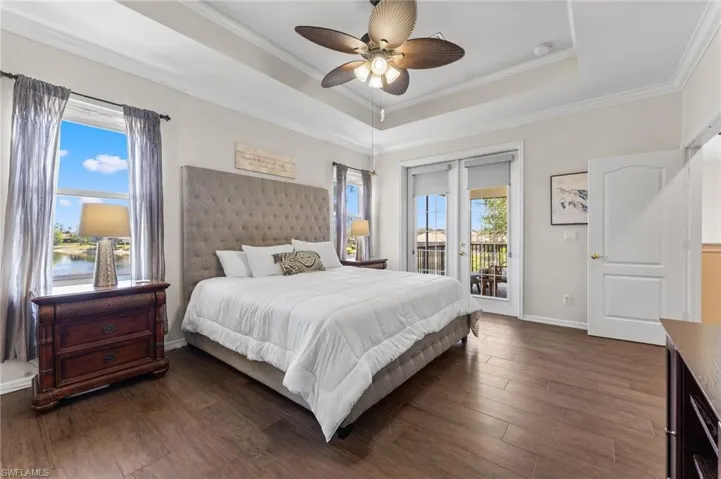 Light floods your primary suite with 2 windows, doors to your private screened balcony over looking the pool and pond. Window treatments and drapes stay with home.
