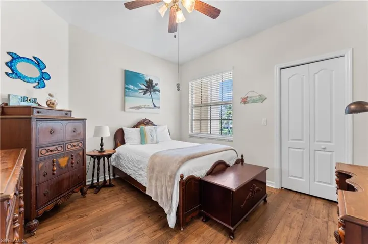 Secondary Bedroom with Pergo Flooring and Walk-in Closet