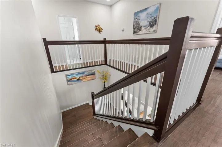 Painted Staircase with Spindles and Tile Wood Flooring