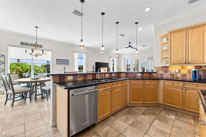 Spacious Kitchen with island and peninsula with pendant and under cabinet lighting
