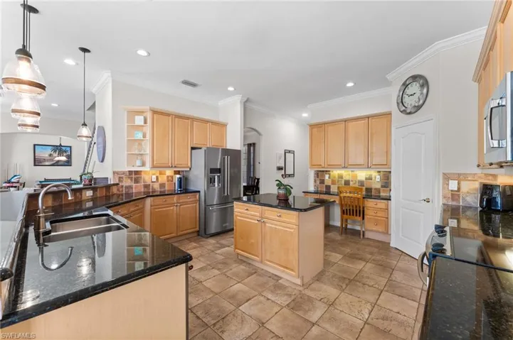 Light Maple Cabinetry and Granite Countertops plus a walk-in pantry and kitchen desk