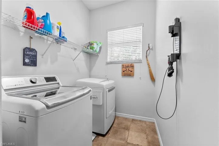 Laundry Room with LG Washer and Dryer and wire shelving for additional storage.