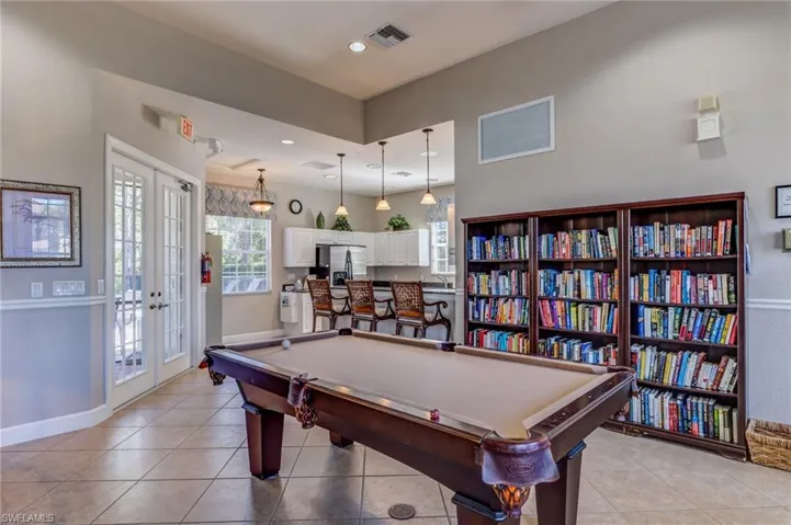 Community social room with pool table and library