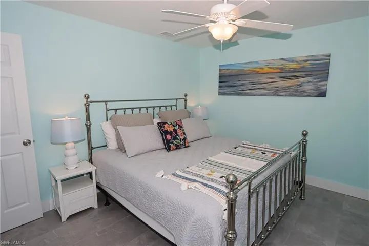Bedroom featuring dark tile flooring and ceiling fan
