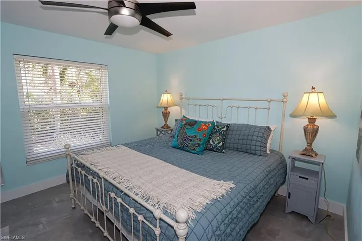 Bedroom featuring ceiling fan and dark tile floors