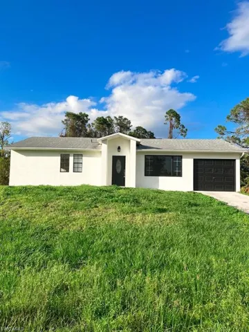 Single Story Home with Stucco Siding, a Garage, Concrete Driveway