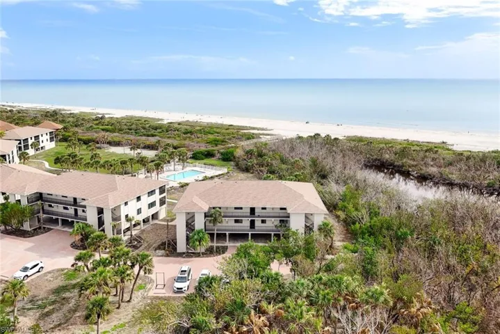 Drone / aerial view with a water view and a beach view