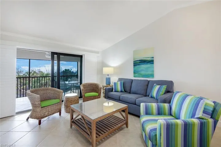 Tiled living room with lofted ceiling