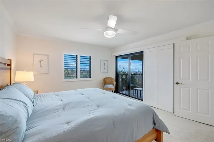 Bedroom with ceiling fan, access to exterior, light carpet, and crown molding
