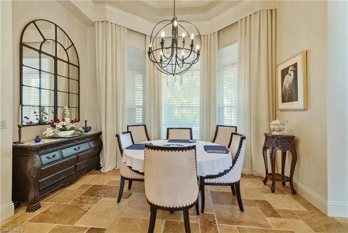 Dining area featuring a chandelier and crown molding