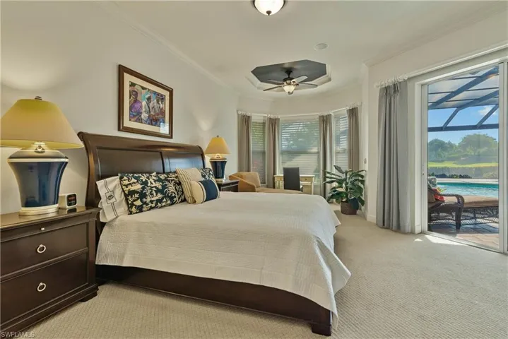 Bedroom with ornamental molding, ceiling fan, light colored carpet, and access to outside