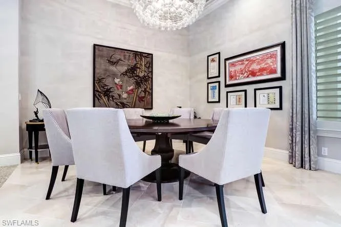 Tiled dining room featuring a notable chandelier