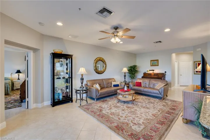 Living room featuring recessed lighting, ceiling fan, and light tile patterned floors