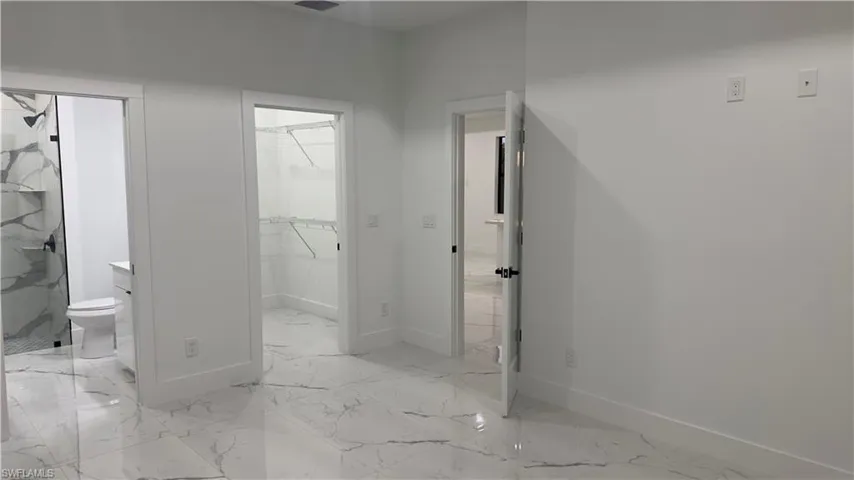 Hallway featuring light tile floors