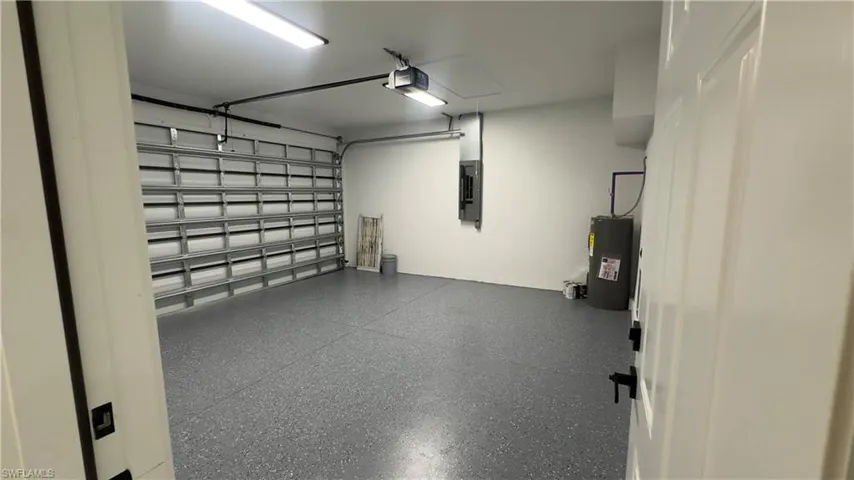 Garage with a garage door opener and water heater