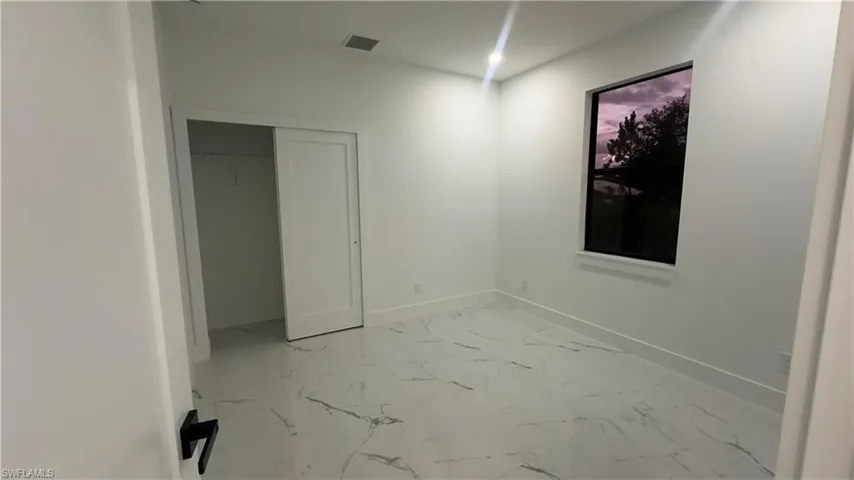 Unfurnished bedroom featuring tile flooring